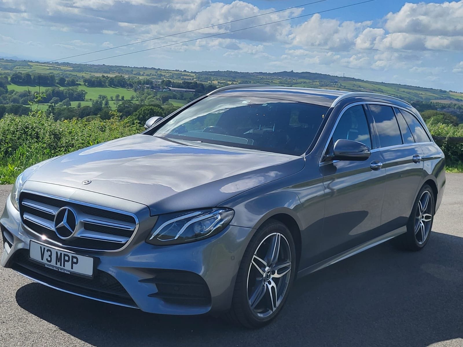 The Top Marks Airport Services Mercedes-Benz E-Class Estate, front three-quarter view on a country road