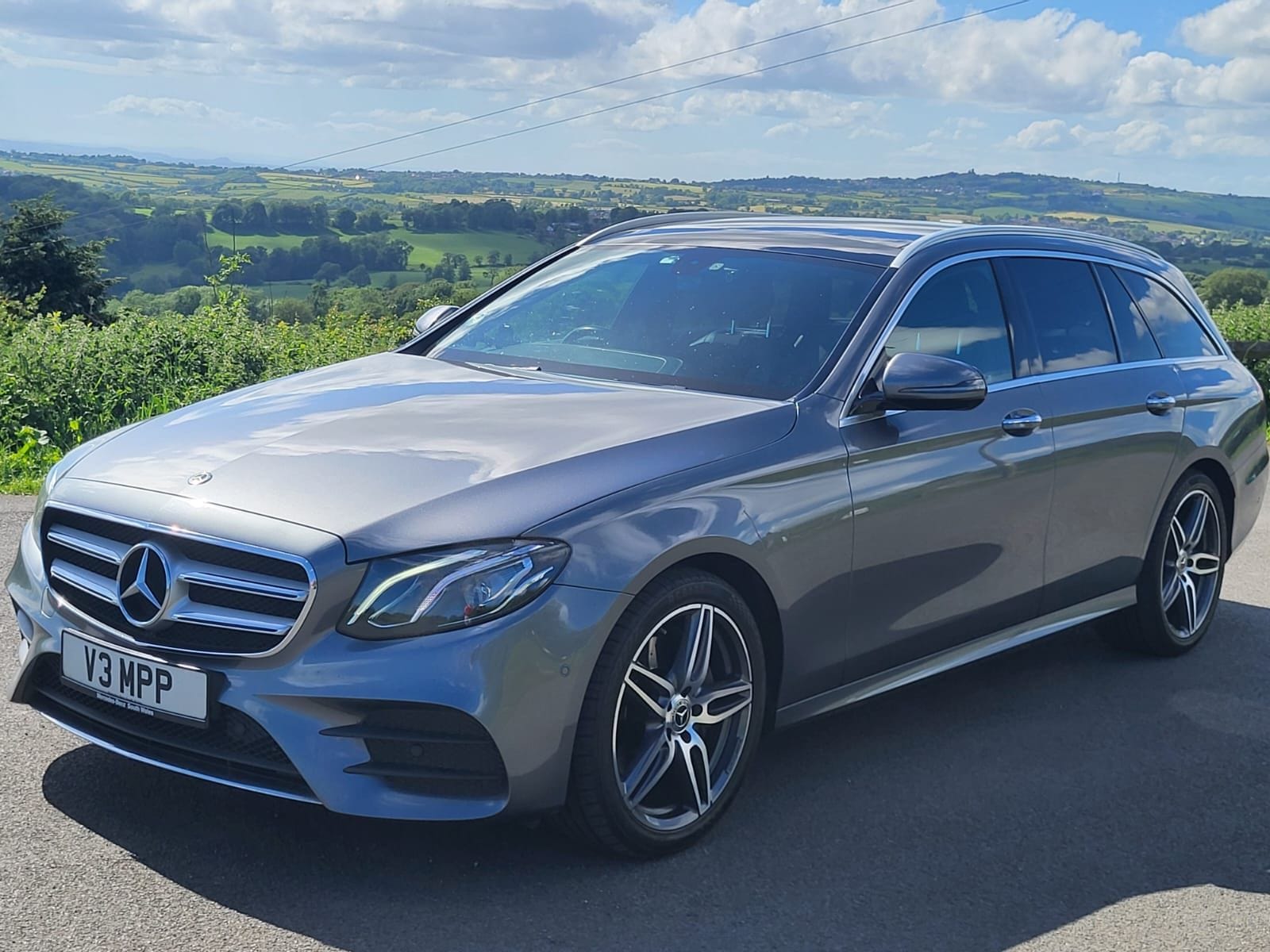 A Top Marks Mercedes-Benz on a country lane beside a hedgerow